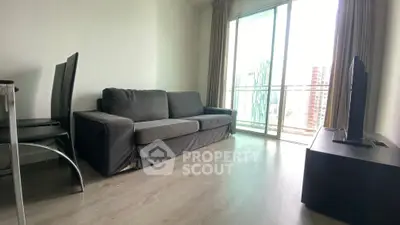 Modern living room with sleek furniture and city view balcony in high-rise apartment.