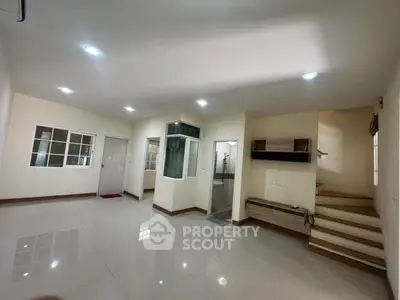 Spacious modern living room with sleek design and ample natural light, perfect for family gatherings.