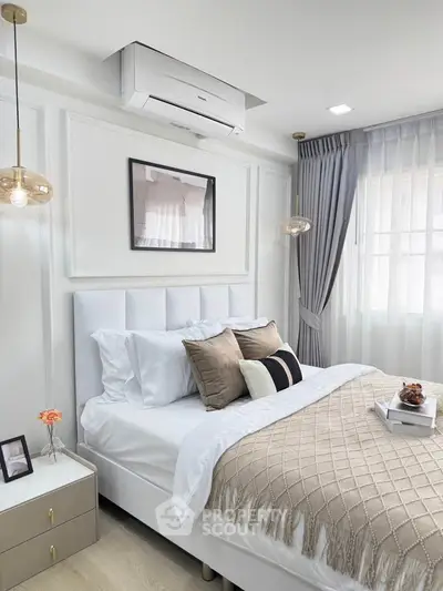 Elegant bedroom with modern decor, cozy bedding, and natural light for a serene atmosphere.