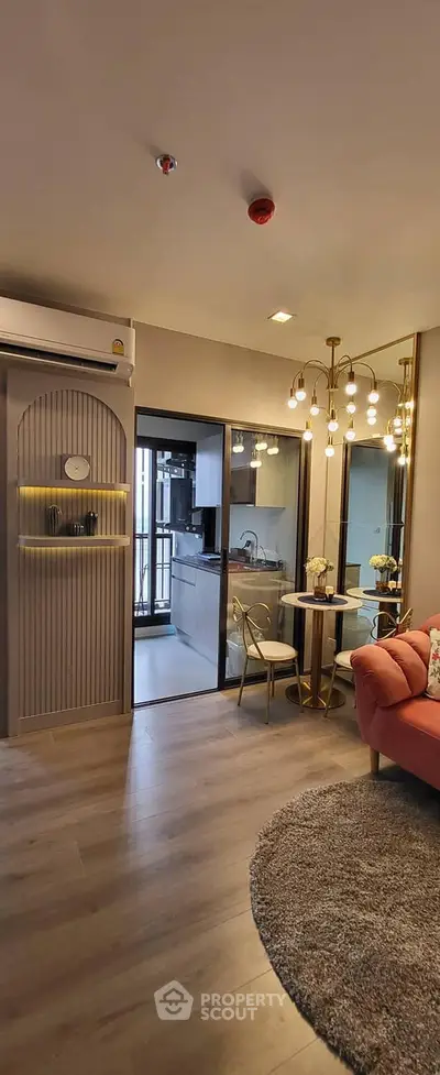 Modern living room with stylish decor and open kitchen layout in a chic apartment.