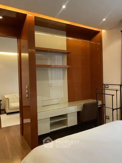 Luxurious bedroom with built-in desk and modern shelving, perfect for stylish living.