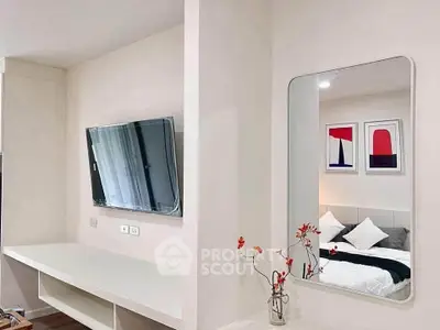 Modern bedroom with wall-mounted TV and stylish decor