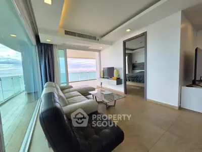 Luxurious beachfront living room with stunning ocean view and modern furnishings.