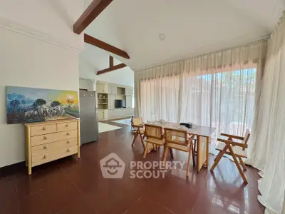 Spacious dining area with natural light and modern decor in a stylish home.