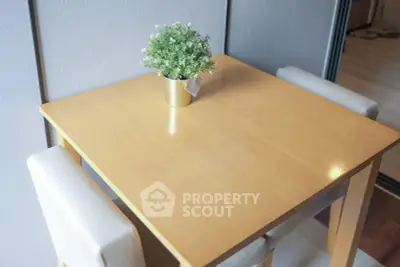 Cozy dining area with wooden table and modern chairs, perfect for intimate meals.