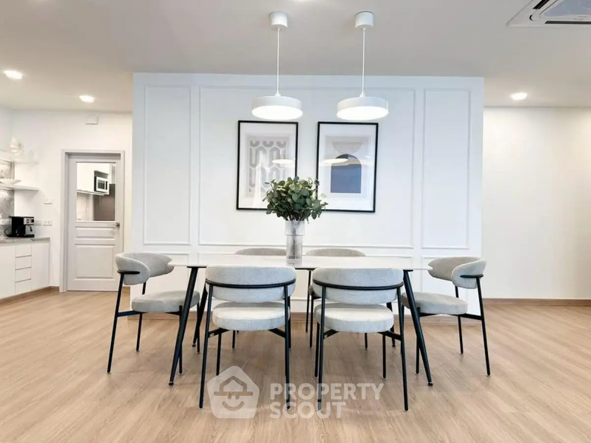 Elegant dining room with modern decor and stylish lighting in a contemporary home.