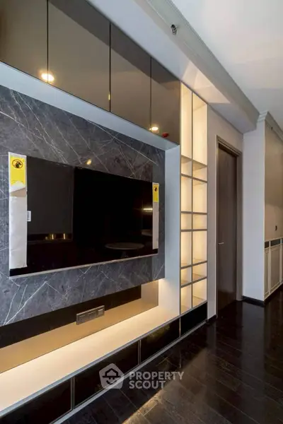 Modern living room with sleek TV wall unit and ambient lighting