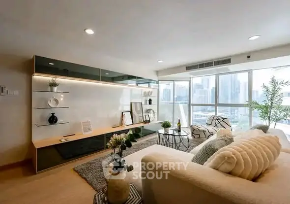 Spacious modern living room with city view, elegant decor, and natural light.