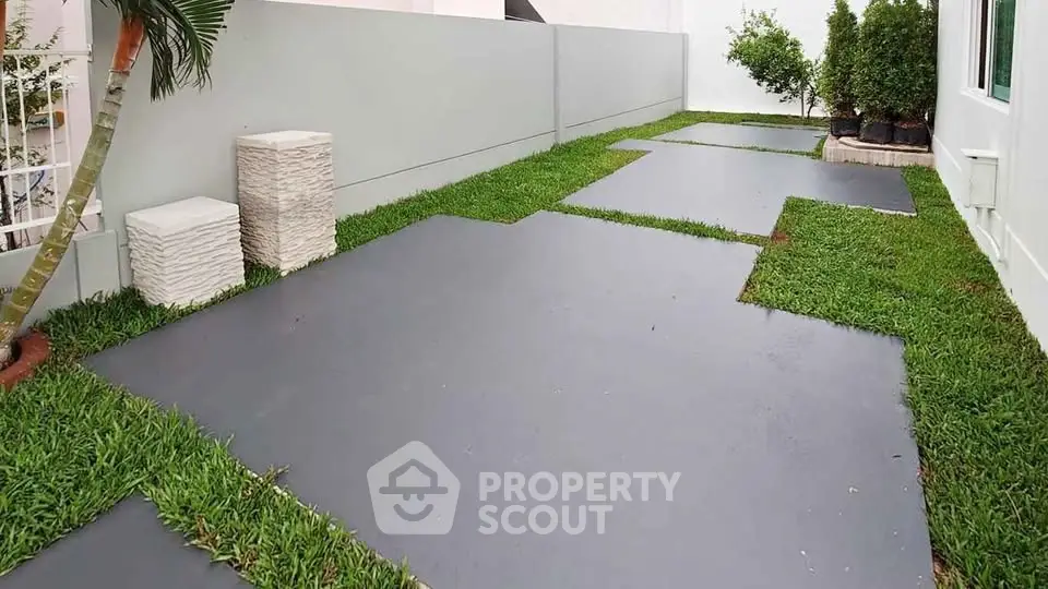 Modern garden with sleek stone pathways and lush greenery