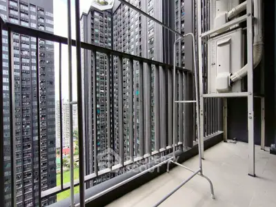 Modern high-rise balcony with cityscape view, perfect for urban living enthusiasts.