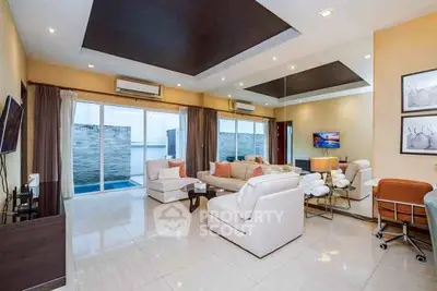 Luxurious modern living room with elegant decor and large windows offering stunning views.