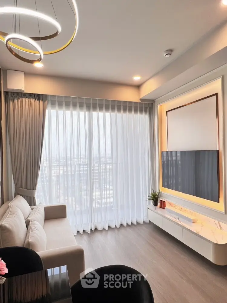 Modern living room with elegant lighting and floor-to-ceiling windows