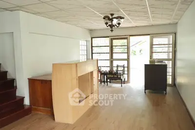 Spacious living room with natural light and wooden flooring
