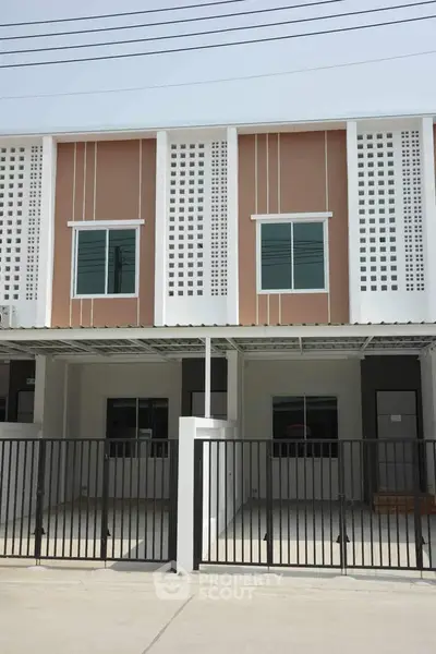 Modern townhouse exterior with gated parking and stylish facade