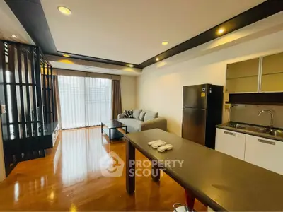 Modern open-layout living room with sleek kitchen and stylish decor