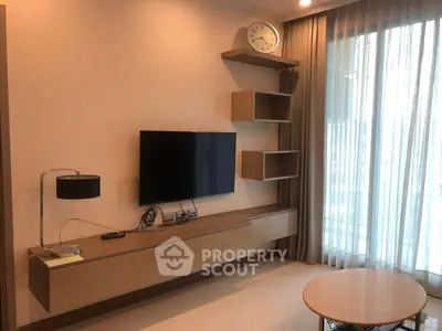 Modern living room with wall-mounted TV and stylish shelving