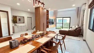 Spacious modern living and dining area with elegant decor and large windows.