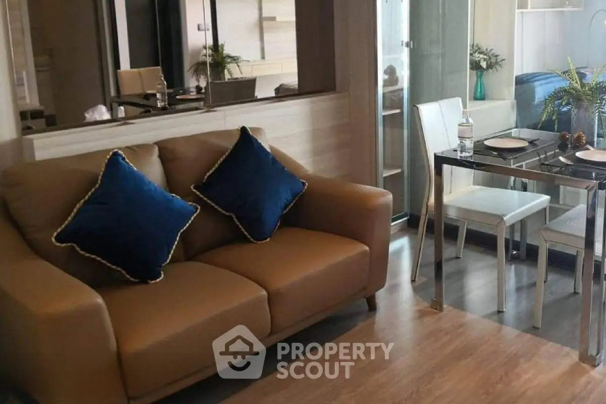 Modern living room with cozy sofa and elegant dining area in open-plan layout.