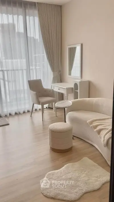 Elegant living room with modern furniture and large window, perfect for natural light lovers.