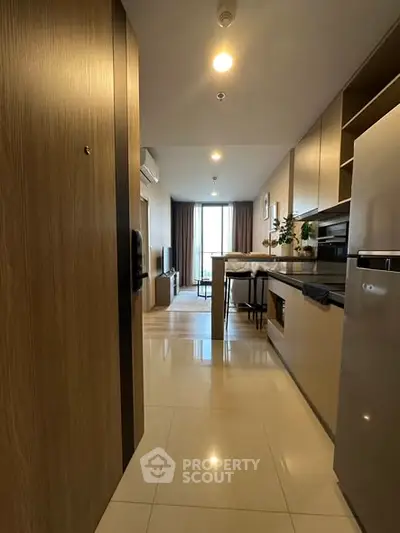 Modern open-layout kitchen and living area with sleek design and natural light.