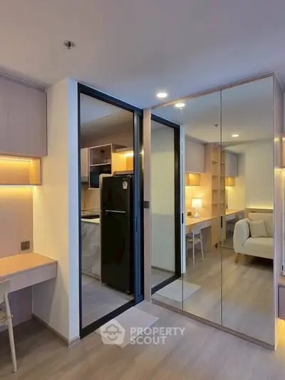 Modern apartment interior with mirrored closet and cozy living area