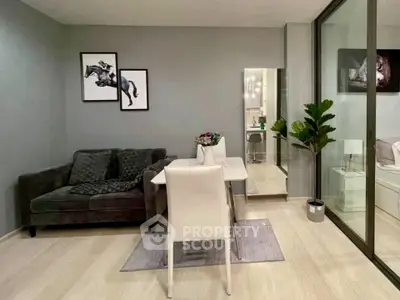 Modern living room with sleek decor and glass partition