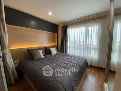 Cozy bedroom with large bed and natural light from window