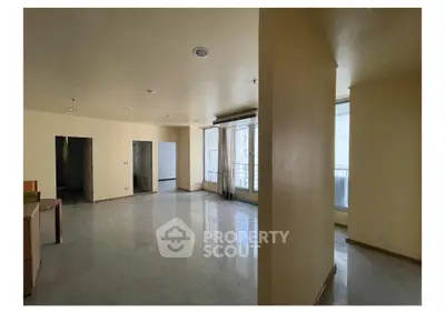 Spacious empty living room with large windows and natural light