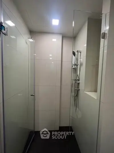 Modern bathroom with glass shower enclosure and sleek fixtures