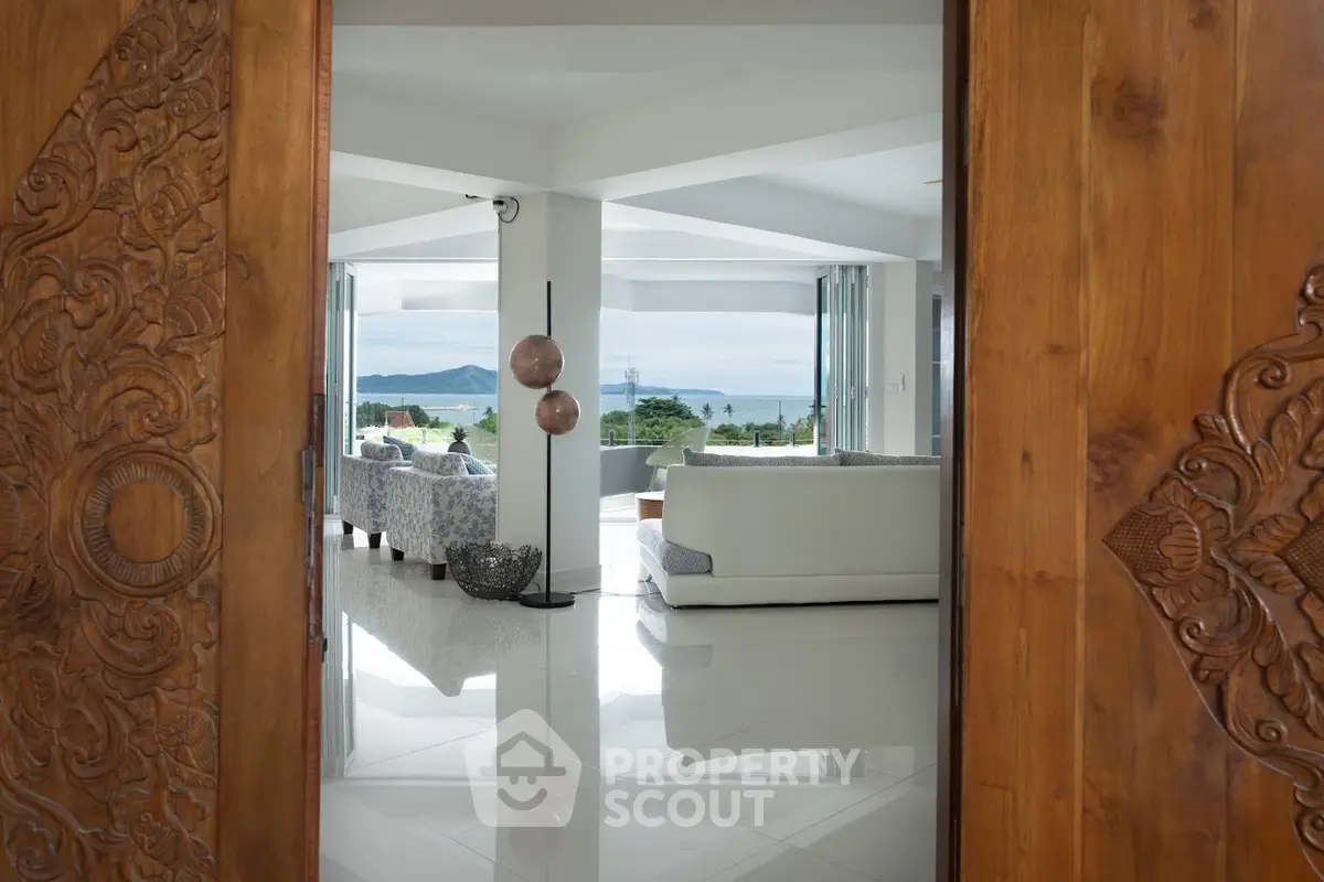 Luxurious living room with ocean view, elegant decor, and spacious open layout.