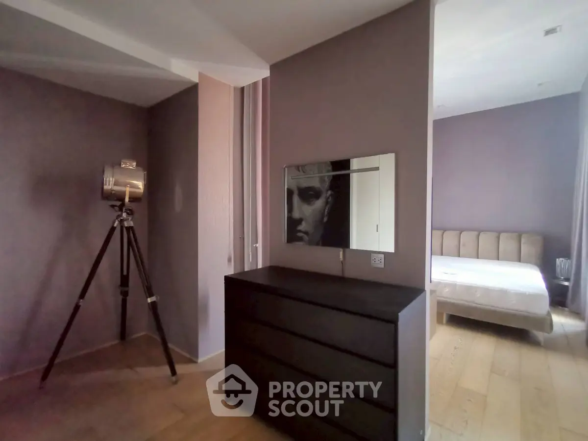 Modern bedroom with stylish decor and wooden flooring