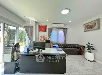 Modern living room with sleek decor, large windows, and stylish furniture in a bright, airy space.