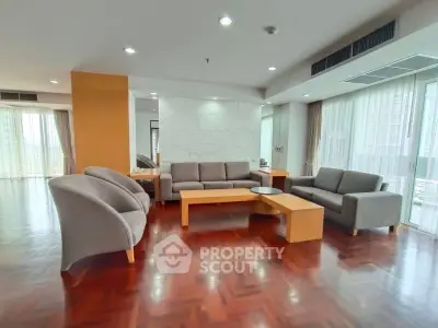 Spacious modern living room with elegant furniture and large windows for natural light.