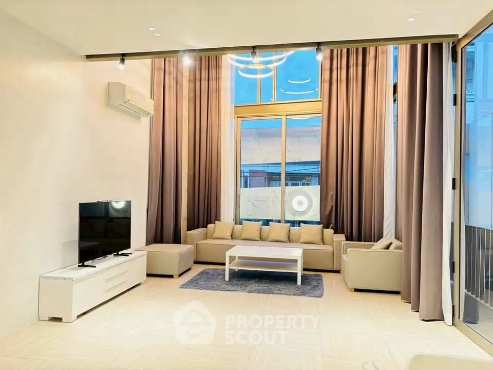 Spacious modern living room with high ceilings and elegant decor