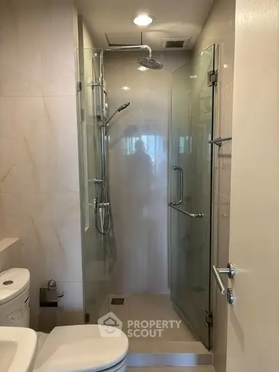 Modern bathroom with glass shower enclosure and sleek fixtures