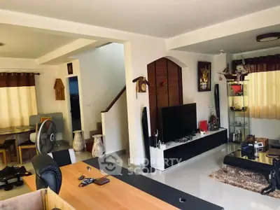 Spacious living room with modern decor and entertainment center