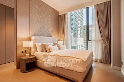 Luxurious bedroom with floor-to-ceiling windows and elegant decor in modern apartment.