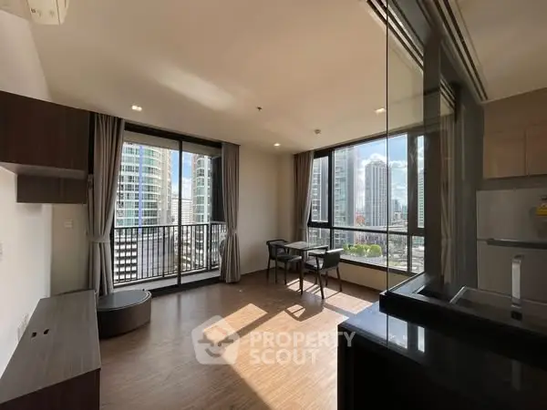 Modern apartment with large windows and city view, featuring open layout and stylish furnishings.
