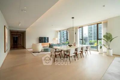 Spacious modern living room with dining area and large windows offering city views.