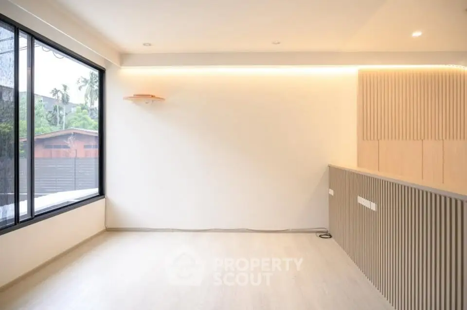 Modern minimalist living room with large window and wooden accents