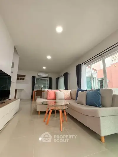 Spacious modern living room with stylish furniture and large windows for natural light.