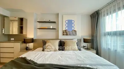 Modern bedroom with stylish decor and large window for natural light.