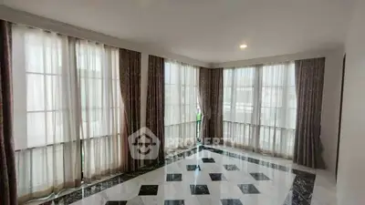 Spacious corner unit with elegant floor-to-ceiling windows and luxurious marble flooring.