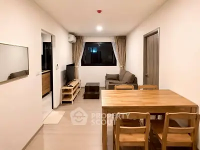 Modern living room with wooden dining set and cozy sofa, perfect for urban living.