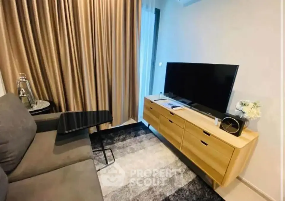 Modern living room with sleek furniture and large TV, perfect for relaxation.