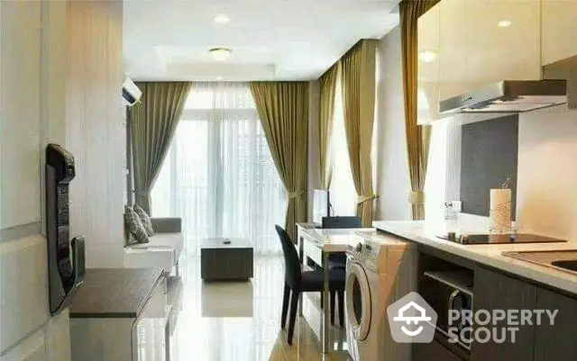 Modern apartment interior with open kitchen and living area, featuring sleek design and natural light.