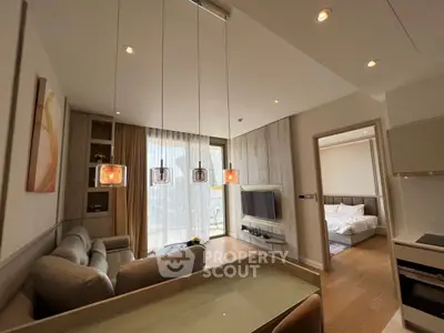 Modern open-layout living room with elegant lighting and cozy bedroom view.