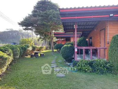 Charming rustic cabin with lush garden and cozy porch, perfect for serene countryside living.