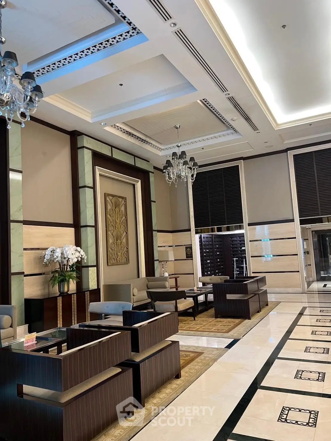Luxurious building entrance with elegant seating and chandeliers