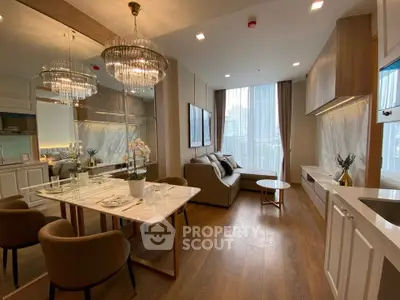 Luxurious modern living room with elegant dining area and city view, featuring chic chandeliers and stylish decor.